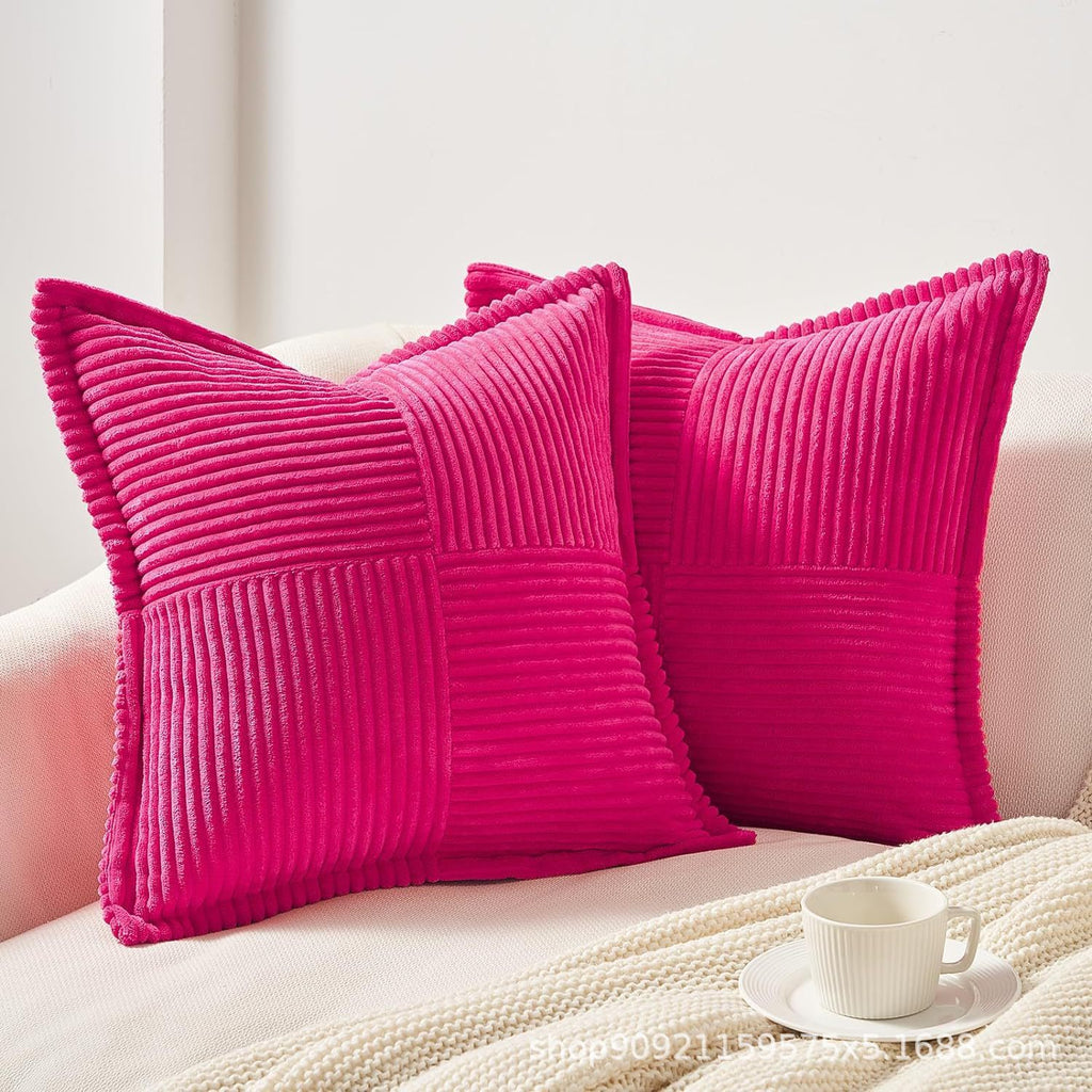 Hot pink corduroy pillow covers with bold striped texture, adding a vibrant touch to decorative couch cushions.